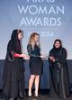 HE Ameera Bin Karam and Emma Henry (Fragrance Du Bois) presenting the award for Sport to Khadijah Mohammed (Olympic weightlifting competitor)