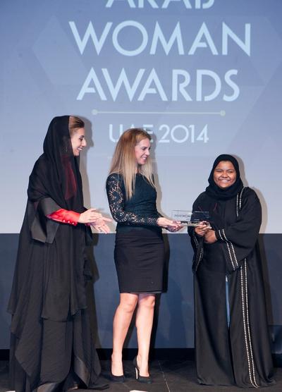 HE Ameera Bin Karam and Emma Henry (Fragrance Du Bois) presenting the award for Sport to Khadijah Mohammed (Olympic weightlifting competitor)