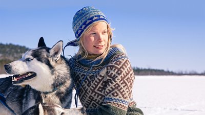 Tinja Myllykangas who lives with dozens of dogs in the wilderness of Lapland