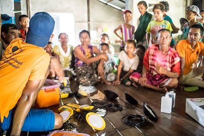 SolarHome rep providing system demo in a village in Ayeayerwadi region in Myanmar