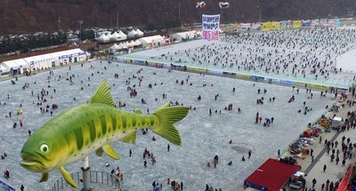 This 2017 file photo shows visitors watching sancheoneo, a type of mountain trout, during the annual Hwacheon Sancheoneo Ice Festival in Hwacheon