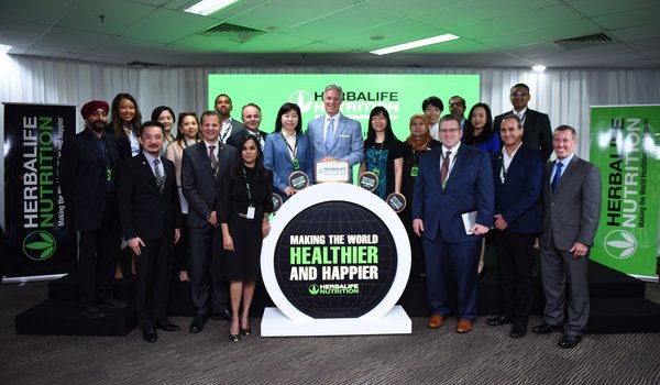 Herbalife CEO Rich Goudis (center) at the launch of the new Asia Pacific Shared Services Center, with Herbalife executives and guests, including Dato' Ng Wan Peng, COO of MDEC (to Goudis' left), Lim Bee Vian, Executive Director, Strategic Planning (Services), MIDA (to Goudis' right), Stephen Conchie, senior vice president and managing director, Herbalife Asia Pacific (fifth from left, second row), and Dean Thompson, Deputy Chief of Mission, US Embassy in Malaysia (third from right, front row).