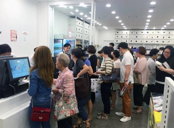 Consumers waiting in line for payment in MINISO