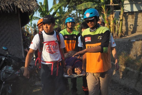 ACT emergency response team rescues a victim from a house's ruins