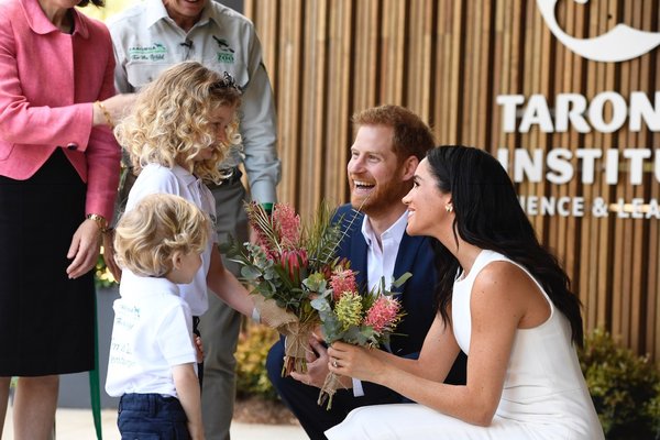 Harry and Meghan - flower presentation at ribbon cutting