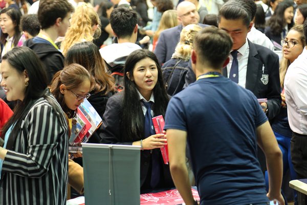Harrow Students communicate with College Representative from University Fair.