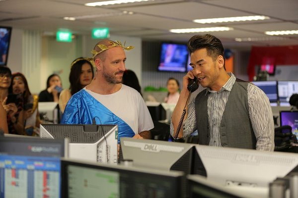 Hong Kong actor Michael Tong (right) closing a deal on the phone in ICAP Singapore office during ICAP Charity Day on Wednesday 5 December 2018