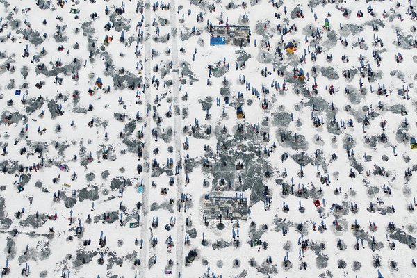 This undated file photo shows visitors ice fishing for pond smelt during the Inje Icefish Festival in Inje, a mountainous town 165 kilometers east of Seoul.