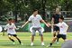 武磊与友邦中国青少年足球发展项目的小球员进行足球互动