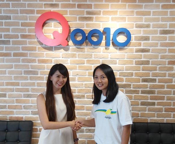 Rachel Ho from Qoo10 (left) celebrates the new partnership with Angela Tan of RebateMango (right).