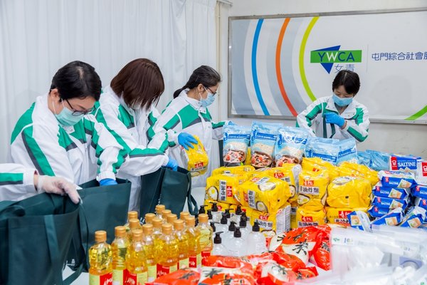 Volunteers from the Hang Lung As One Volunteer Team help package the health and food kits