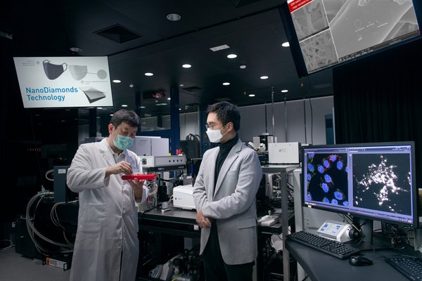 Caption II: New World Development CEO Adrian Cheng (right) met with leading nanotechnology company Master Dynamic to learn how to apply the patented NanoDiamonds technology to the production of low-cost, antibacterial masks. Picture shows Dr. Tom Kong, CEO of Master Dynamic showing Adrian Cheng a sample of NanoDiamonds.