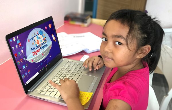 Nur Muliana Binte Mamat, a Primary 2 student from Fuhua Primary School who has received a UOB digital learning kit to aid in her home-based learning