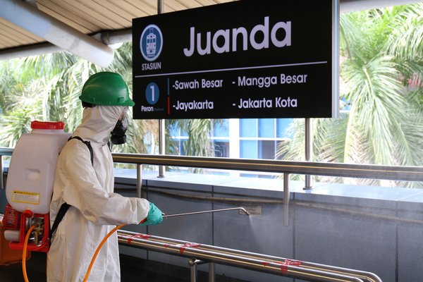 Worker Sprays Disinfection Liquid on Stations and Trains Daily.