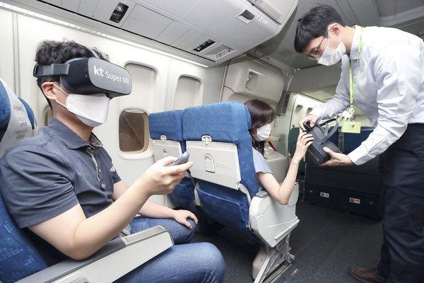 Passengers on a flight view immersive media contents via the KT Super VR service.