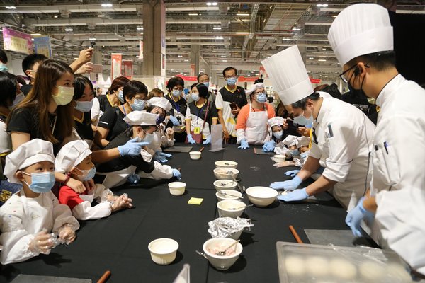 Children learn how to prepare food in the Luso International (LIB) Presents: Little Master Chef Workshop and play games at booths at the Sands Shopping Carnival at The Venetian Macao’s Cotai Expo.