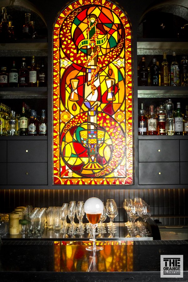 TBD专属饮酒仪式中的“四大元素”：酒杯、摇酒器、匕首、蛇被解构重组嵌入了彩绘玻璃。