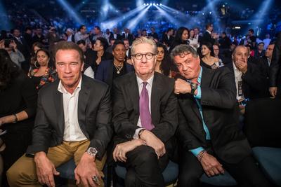 Hollywood action heroes Arnold Schwarzenegger and Sylvester Stallone sit with Edward Tracy, President and Chief Executive Officer of Sands China Ltd., at the Clash in Cotai II at the Venetian Macao’s Cotai Arena where Manny Pacquiao defeated Chris Algieri in their WBO world welterweight clash.