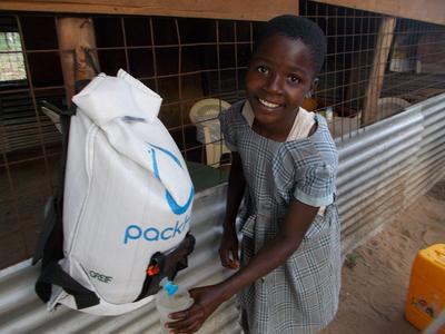 Young girl uses PackH2O water backpack. Photo by Partners for Care