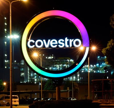 The new Covestro logo lights the night sky at the site in Shanghai, China.