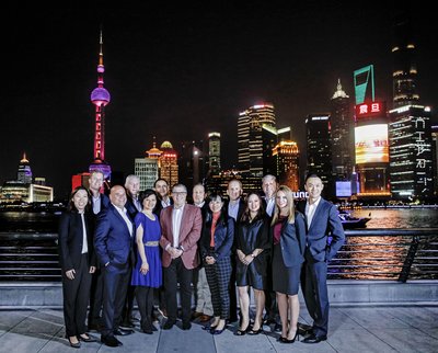 Pictured (left to right) is the Norwegian Cruise Line Holdings (NCLH) team on the Bund in Shanghai: Kimberly Leung, William Harber, David Herrera, Robin Lindsay, Winnie Chan, Simon Ho, Frank Del Rio (NCLH CEO), Richard Ambrose, Dorothy Mak, Harry Sommer, Constance Seck, Mark Kansley, Carmen Santamaria, and Caleb Wang.
