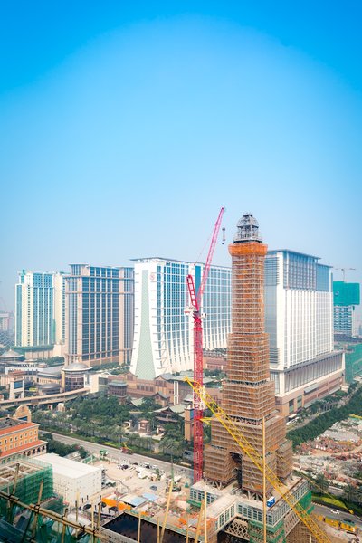 A crane places a lantern atop The Parisian Macao's Eiffel Tower at a topping out ceremony Thursday. Sands China's newest integrated resort and its half-scale replica Eiffel Tower are slated to open in the second half of 2016.