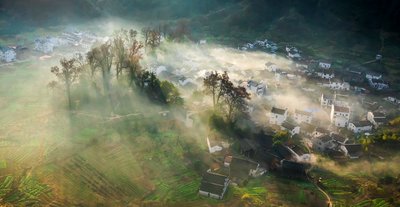 Morning mist draping Shicheng Village in Wuyuan County