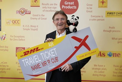 DHL Express CEO Ken Allen with the panda cub's birthday present -- a flight ticket on DHL's global network from Belgium to China