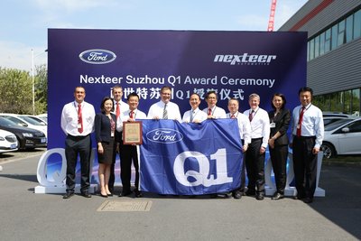 Stefan Sonnenschein, Purchasing Director at Ford APA handed Ford Q1 flag and plaque to Nexteer AP management team