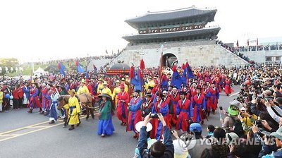 Participants of the 2016 King Jeongjo Tomb Parade Reenactment walk pass Janganmun, the northern gate of Hwaseong Fortress in Suwon, 50 kilometers south of Seoul, on Oct. 9, 2016.