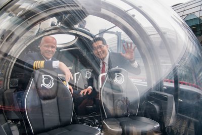 Captain Jukka Silvennoinen, of Dream Cruises inaugural cruise ship Genting Dream, shows, Mr Gregory So Kam-leung, GBS, JP, Secretary for Commerce and Economic Development the controls of one of the ship's state-of-the-art submersibles.