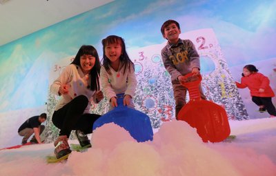 Laughter and fun fill Times Square's White Christmas as children build giant snowballs in the colourful Snow Chamber.