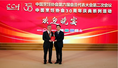 李惠中先生（左）获姜俊贤会长（右）颁中国餐饮30年功勋人物奖