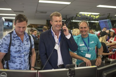 Australian television journalist and news presenter Peter Overton successfully completes a trade during ICAP's Charity Day in Sydney, Australia