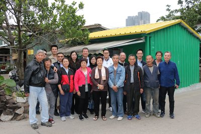 船人街及荔枝碗居民、金沙中国及本地承建商代表于其中一间金沙中国协助修复的房屋前合照留念。