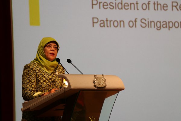 MAIDEN VISIT -- President Halimah Yacob speaks as SUSS Patron and Guest-of-Honour at the NSHD renaming ceremony.