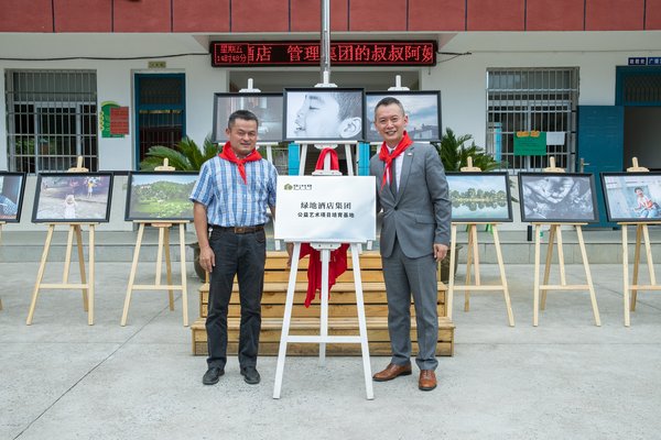 江西上饒縣教體局副局長胡一萍先生與綠地國際酒店管理集團總經(jīng)理助理林江先生為江西上饒楊麟小學(xué)“藝術(shù)教育基地”揭幕