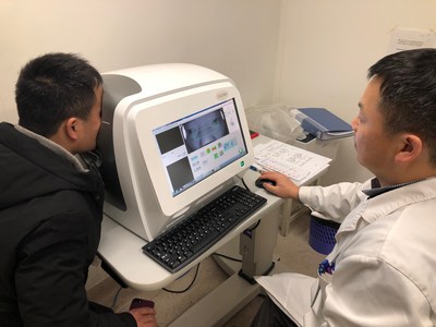 The ophthalmologist operating the optical coherence tomography (OCT) retinal disease screening system