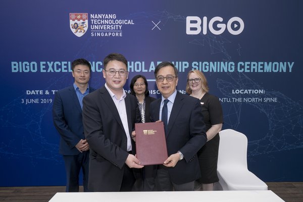 Jason Hu BIGO President (on left) with Prof Alan Chan NTU (on right) with a copy of the signed scholarship agreement