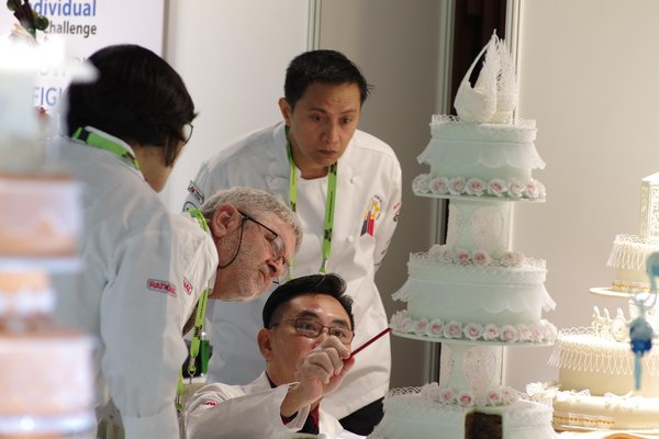 Pastry judges ponder over a competition entry at FCC 2018