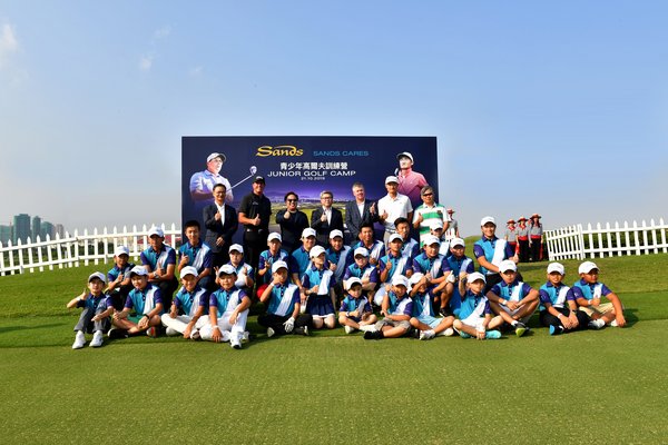 Legendary professional golfer Phil Mickelson, rising Chinese golf star Li Haotong, and officiating guests pose with young golfers in Macao at a junior golf clinic Monday.