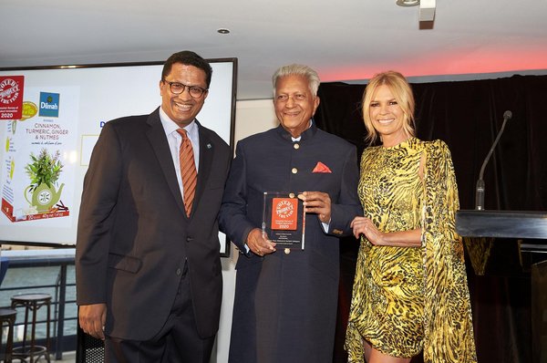 Dilmah Founder Merrill J Fernando receiving the award from Sonia Kruger, joined by his son and Dilmah CEO Dilhan C Fernando