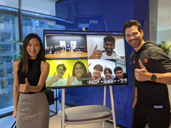 Melissa Tan, Influencer & Host and Bobby Tonelli, Actor & Host celebrating the winners, Team Hollo (Hong Kong) and Team Nutone (Japan) with the Microsoft Imagine Cup judging team (on screen) in Redmond