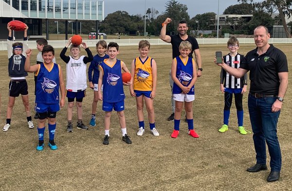 Ex-AFL star, junior footy coach and Team App investor Russell Robertson and Team App CEO Rob Fletcher helping kids get back to training.